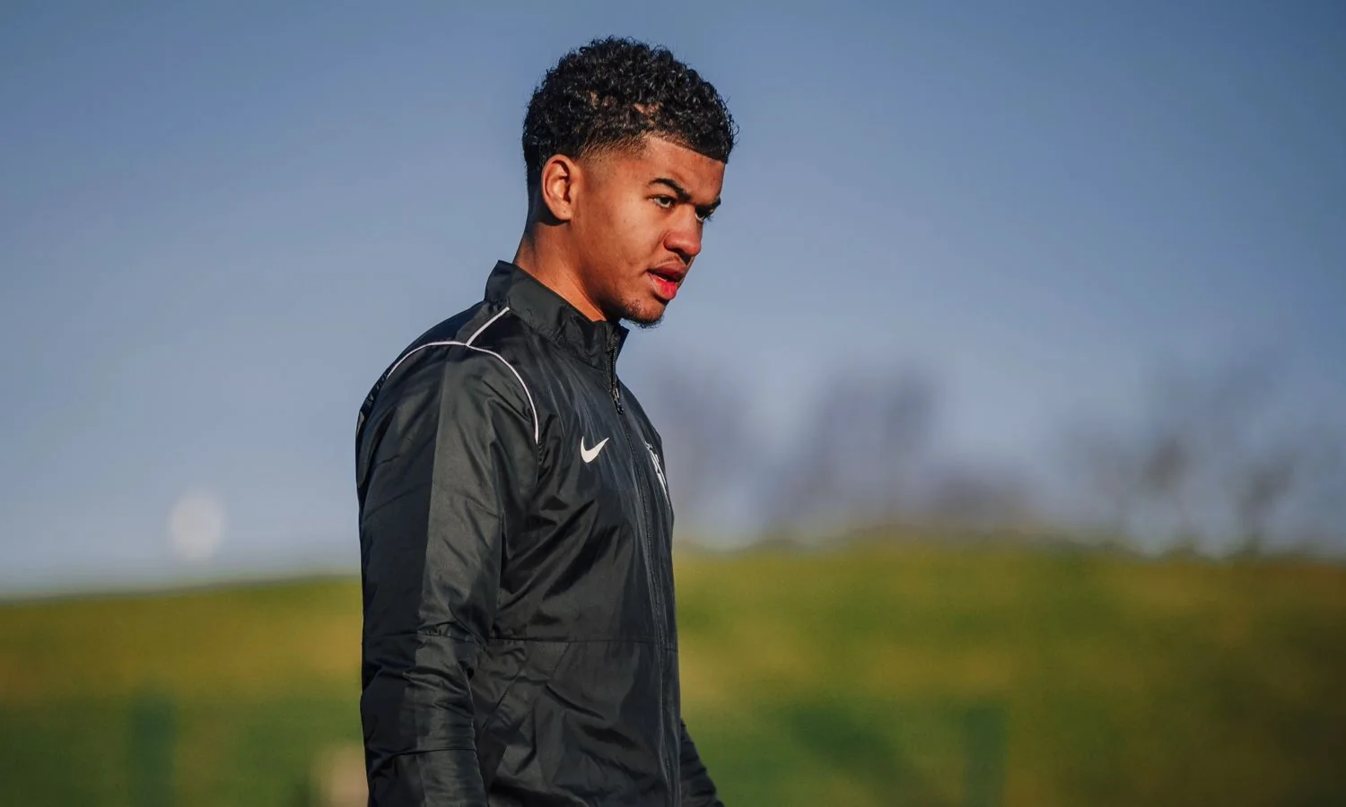 Your coach on the training pitch in a black training jacket